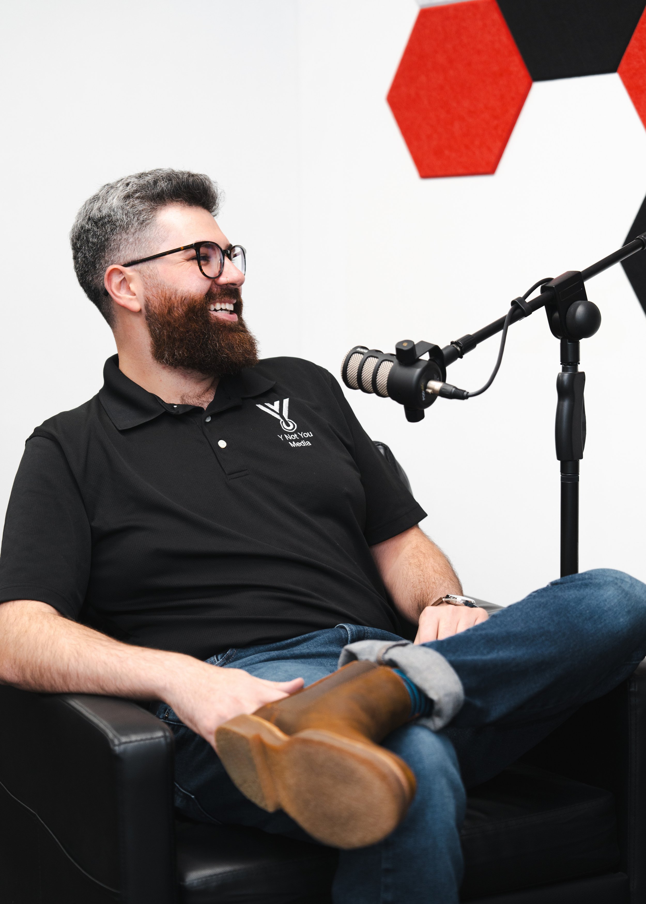 Michael seated at a podcast microphone